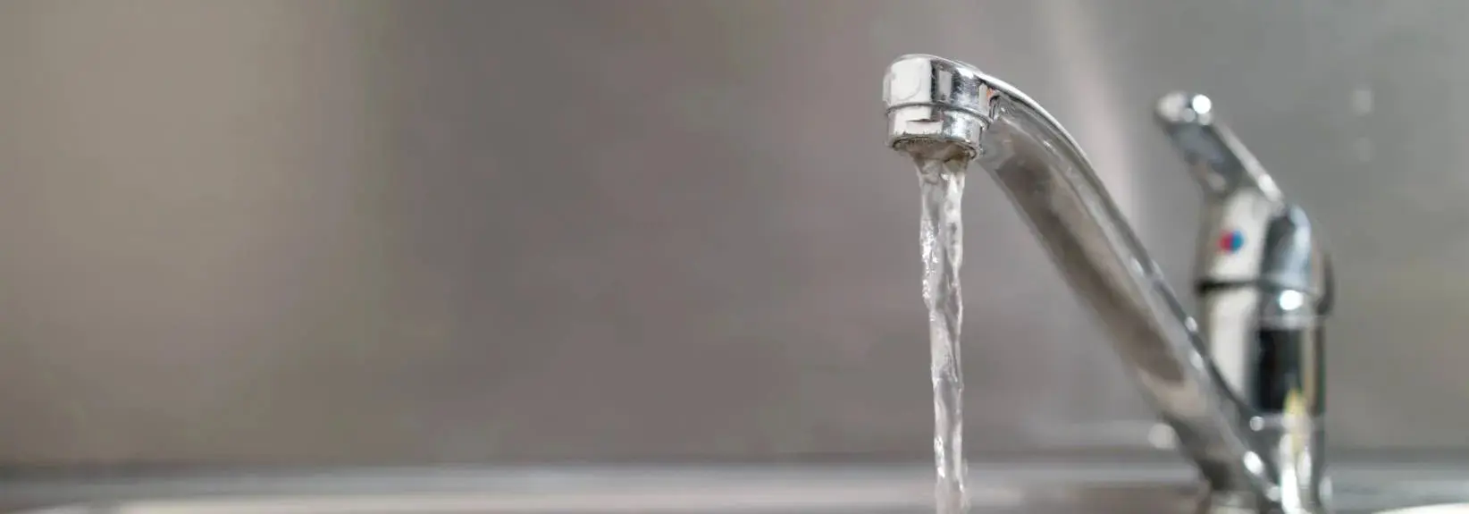 Water flowing out of a faucet.webp